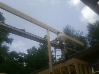 Carpenter setting a ridge beam over a new addition frame — Ice Dam Removal by Roofing Brothers in Sheboygan