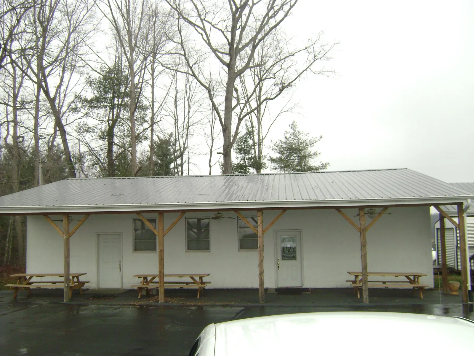 Gray metal roof over a block building with a timber post porch in Sheboygan